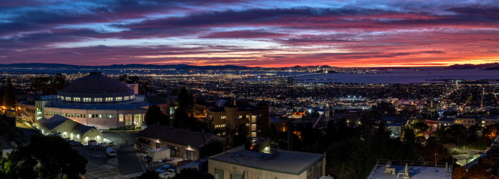 Photograph of Lawrence Berkeley National Laboratory with the San Francisco Bay and San Francisco in the background taken at sunset. 